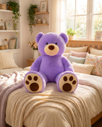 Oversized plush teddy bear on bed, lifestyle